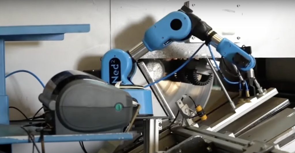 A blue collaborative robot is used in an industrial context to pick objects